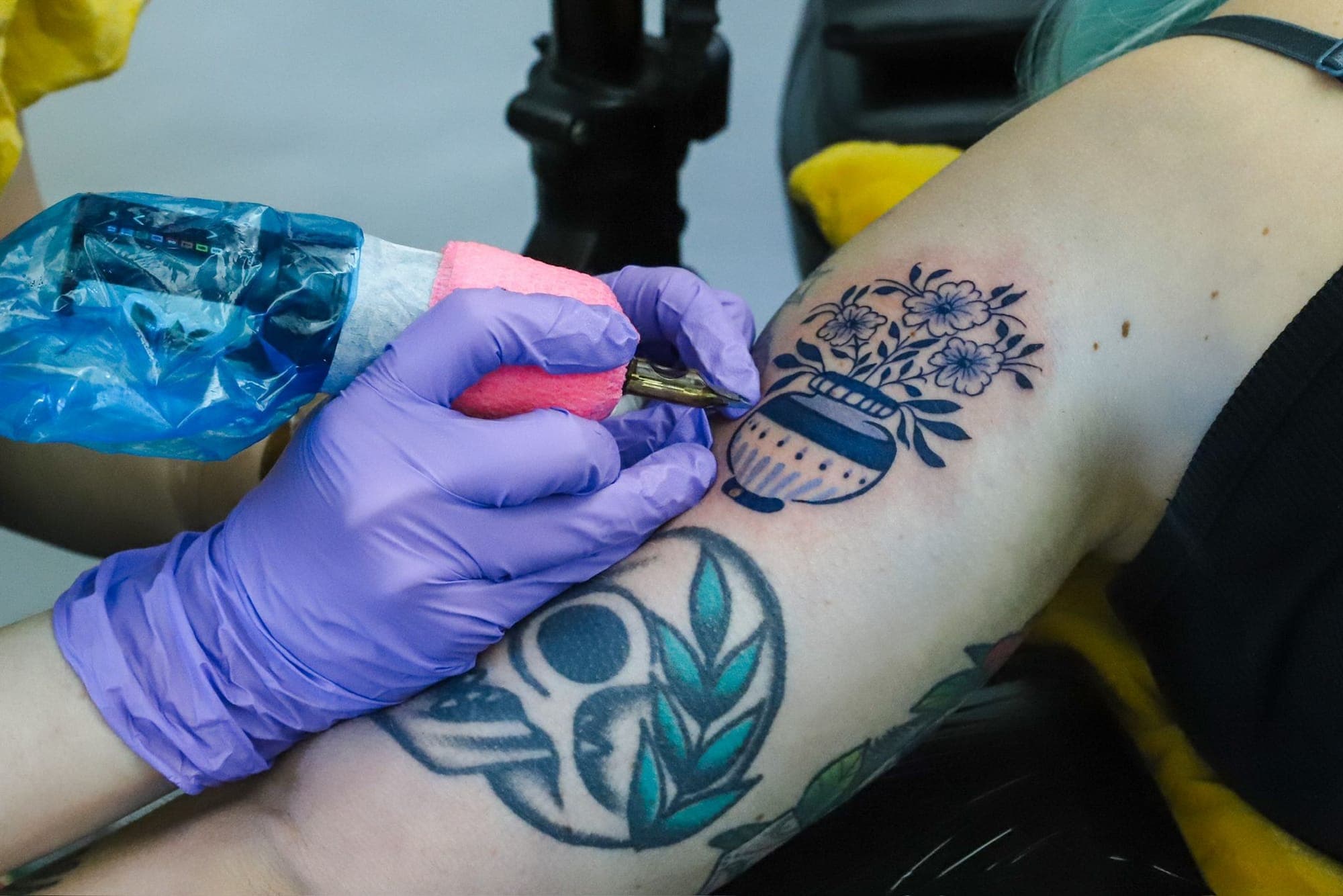 Lydia tattooing a Delft Blue design